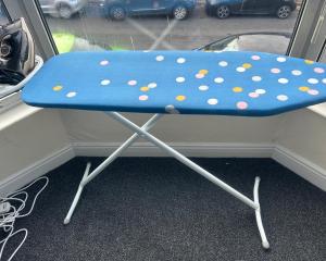 a blue chair with polka dots sitting in front of a window at Students Contractors Professionals in Leicester