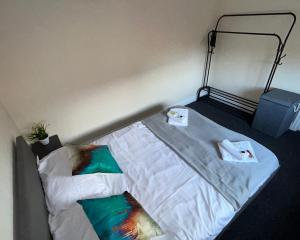 a bed with two pillows on it in a room at Students Contractors Professionals in Leicester