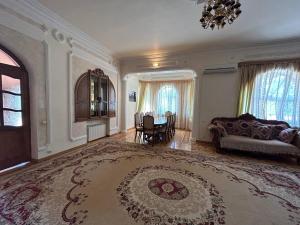 a large room with a bed and a large rug at Red House in Ijevan