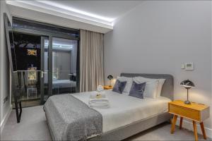 a bedroom with a bed with pillows and a table at Grays Inn by Q Apartments in London