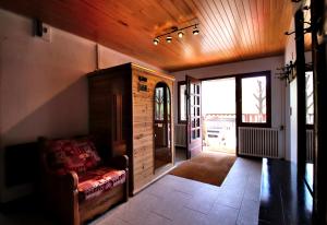 a living room with a couch and a wooden ceiling at Spacious Chalet 16/18 Guests w/Slope View, Jacuzzi et Sauna in Montgenèvre