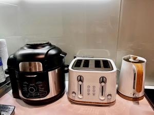 a coffee maker and toaster sitting on a counter at Lakeside LUX bedroom with parking, M4 Jct 11, next to train station in Reading