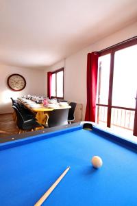 a room with a pool table and a dining room at Spacious Chalet 16/18 Guests w/Slope View, Jacuzzi et Sauna in Montgenèvre