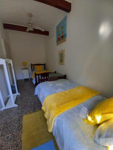 a bedroom with two beds with yellow pillows at Ocean rush barracuda in Zinkwazi Beach