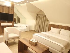 a hotel room with a bed and a chair at Batroun boutique suites in Batroûn