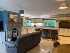 a living room with a couch and a fireplace at Cois Locha in Glenbeigh