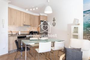 a kitchen and dining room with a table and chairs at Sunset View La Tejita, by Nivariahost in Granadilla de Abona +25 photos