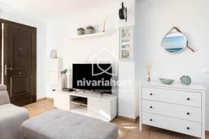 a white living room with a dresser and a mirror at Sunset View La Tejita, by Nivariahost in Granadilla de Abona