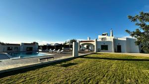 a house with a swimming pool and a yard at Mourisca by Check-in Portugal in Vilamoura