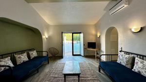 uma sala de estar com dois sofás azuis e uma mesa em Mourisca by Check-in Portugal em Vilamoura