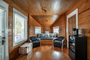 a living room with a couch and two chairs at Airplane Filling Station -Unique Stay in Knoxville in Knoxville