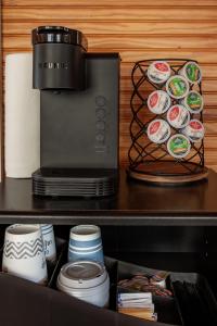 a counter with a coffee maker and cups on a shelf at Airplane Filling Station -Unique Stay in Knoxville in Knoxville