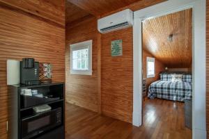 a bedroom with a bed in a room with wooden walls at Airplane Filling Station -Unique Stay in Knoxville in Knoxville