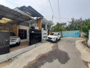 a white car parked in front of a house at Fifa Homestay & Villa 2BR in Tanjungkarang