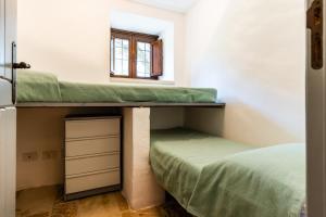 a room with two bunk beds and a window at Sopra i Sassi - Villa & Trulli in Ostuni