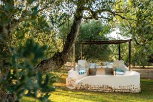 a bed in a gazebo in a garden at Sopra i Sassi - Villa & Trulli in Ostuni