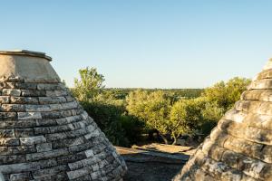 a view from the top of a stone wall at Sopra i Sassi - Villa & Trulli in Ostuni