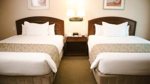 Cama ou camas em um quarto em Los Tallanes Hotel & Suites