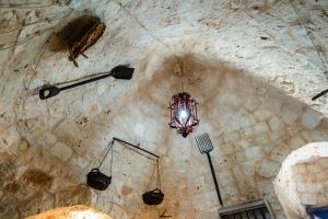 a stone wall with a chandelier hanging from it at Sopra i Sassi - Villa & Trulli in Ostuni