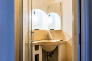 a bathroom with a sink and a mirror at Sopra i Sassi - Villa & Trulli in Ostuni