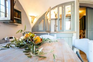 a dining room table with a bowl of fruit on it at Sopra i Sassi - Villa & Trulli in Ostuni