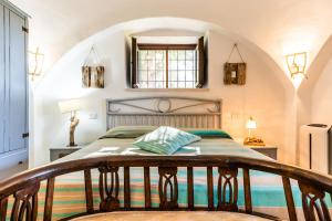 a bedroom with a bed with a wooden headboard at Sopra i Sassi - Villa & Trulli in Ostuni