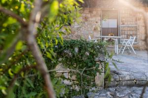a stone house with a table and chairs on a patio at Sopra i Sassi - Villa & Trulli in Ostuni