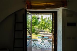 an open door to a patio with a table outside at Sopra i Sassi - Villa & Trulli in Ostuni
