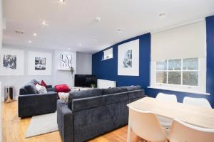 a living room with a couch and a table at The Hepburn Suite - In Central Bath in Bath