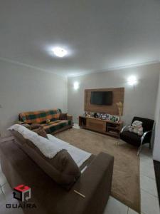 sala de estar con sofá y TV en House en Río de Janeiro