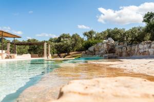 a pool at a resort with a water park at Sopra i Sassi - Villa & Trulli in Ostuni