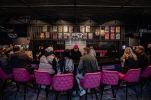 a group of people sitting in chairs at a bar at Brewhalla Hotel in Fargo +93 photos