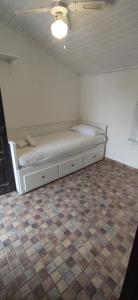 a bedroom with a bed in a room with a tile floor at Villa Conil in Conil de la Frontera