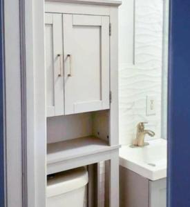 a white bathroom with a sink and a toilet at Stunning 3BR Apartment in NYC! in New York