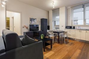 a living room with a couch and a table at Santa Sofia Home in Milan