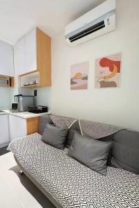a living room with a couch in a kitchen at Seaside Pool View Studio Apartment at Kota Kinabalu City Centre in Kota Kinabalu