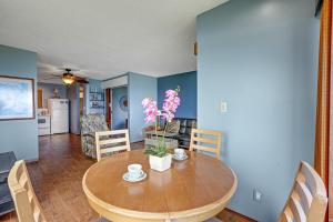 a kitchen and dining room with a wooden table and chairs at Sealodge E4 in Princeville