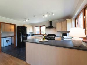 a large kitchen with a large island in the middle at Glenfuran in Tobermory