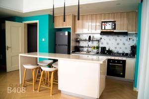 a kitchen with a white island in a room at Laurel Living 2-Bedroom apartment in Nairobi
