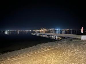 a pier at night with a city in the background at Rêve de Thau in Balaruc-le-Vieux