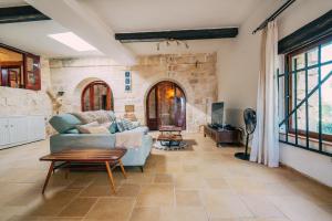 a living room with a couch and a table at Private Villa in Naxxar
