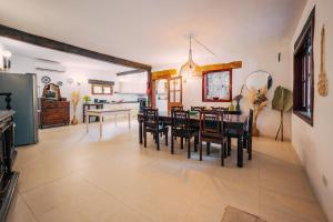 a kitchen and dining room with a table and chairs at Private Villa in Naxxar