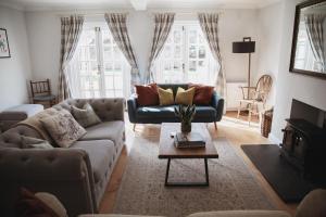 a living room with a couch and a table at Glebe House in Barford Saint Martin
