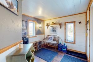 a living room with a chair and a window at Grizzly Pines in Jay