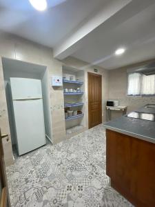 a kitchen with a white refrigerator and a counter at Casa Calderón de Medina lV in Siete Iglesias de Trabancos