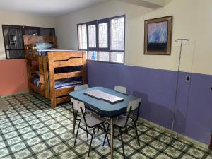 Cette chambre comprend une table et des lits superposés. dans l'établissement El Pueblito, à Cochabamba