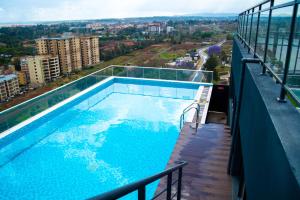 a swimming pool on the balcony of a building at Laurel Living 2-Bedroom apartment in Nairobi