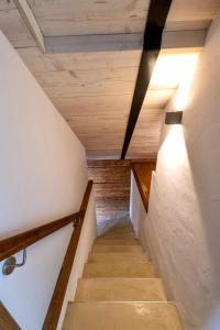 a staircase in a house with wooden ceilings at Chalet Buron 7 in Kaufbeuren