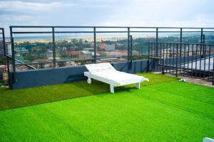 a white bench sitting on top of a roof at Laurel Living 2-Bedroom apartment in Nairobi