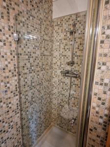 a bathroom with a shower with tiled walls at Airam Home Mirador Centro in Almansa